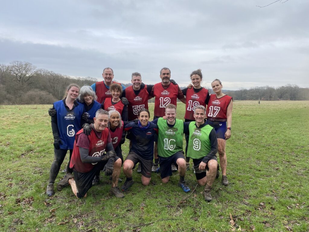 Outdoor exercise group in a muddy park.